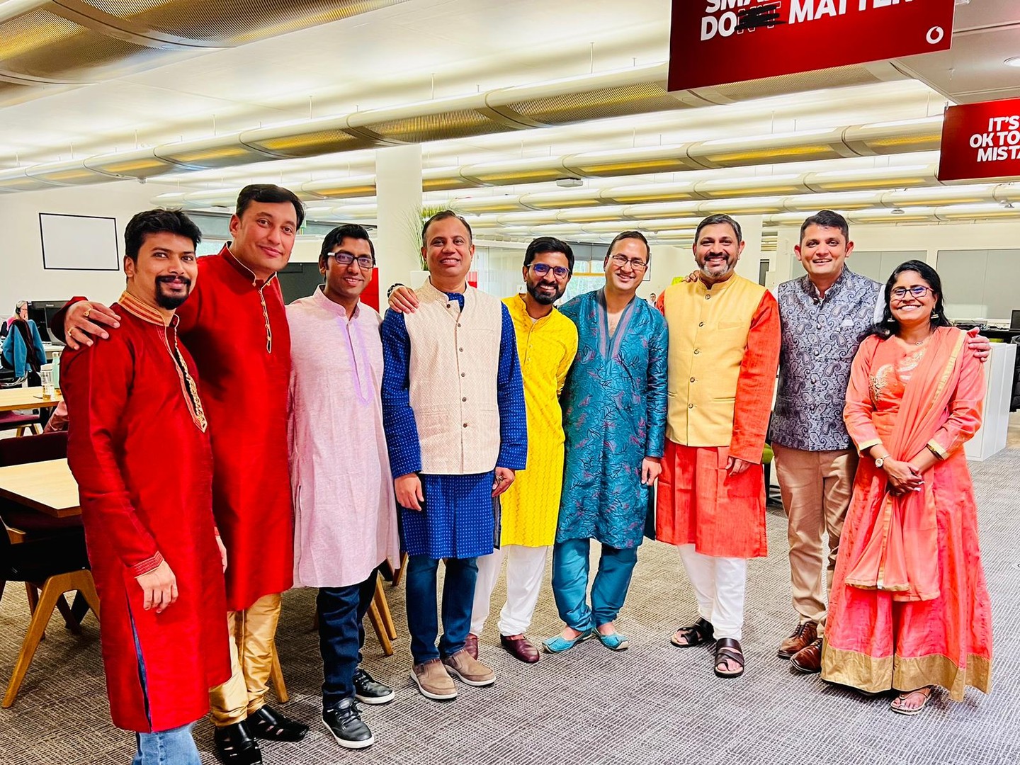 A group of people in traditional clothing to their culture in the office
