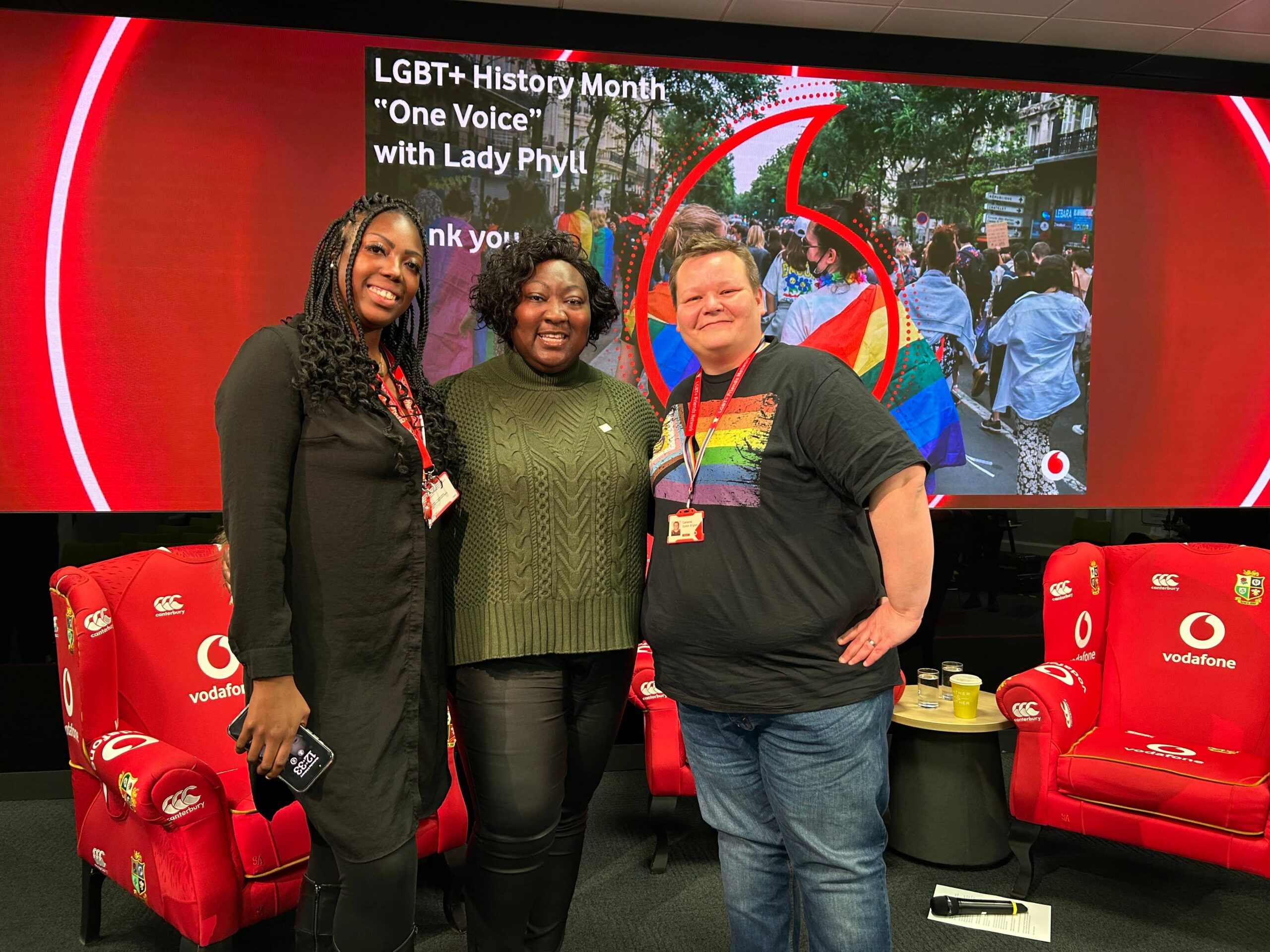 Three women smiling at an internal event for LGBT History Month