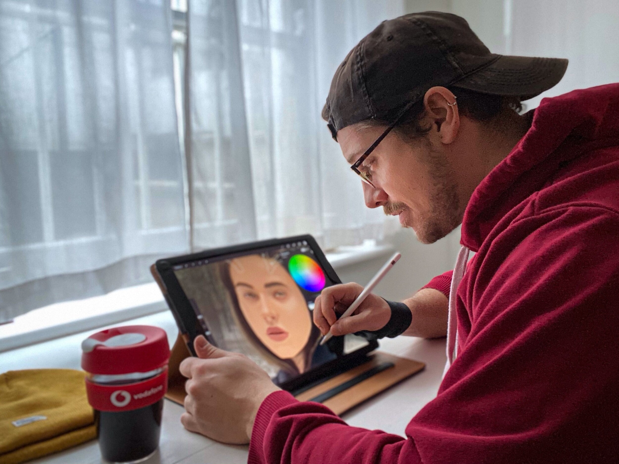 A man editing a photo on an ipad