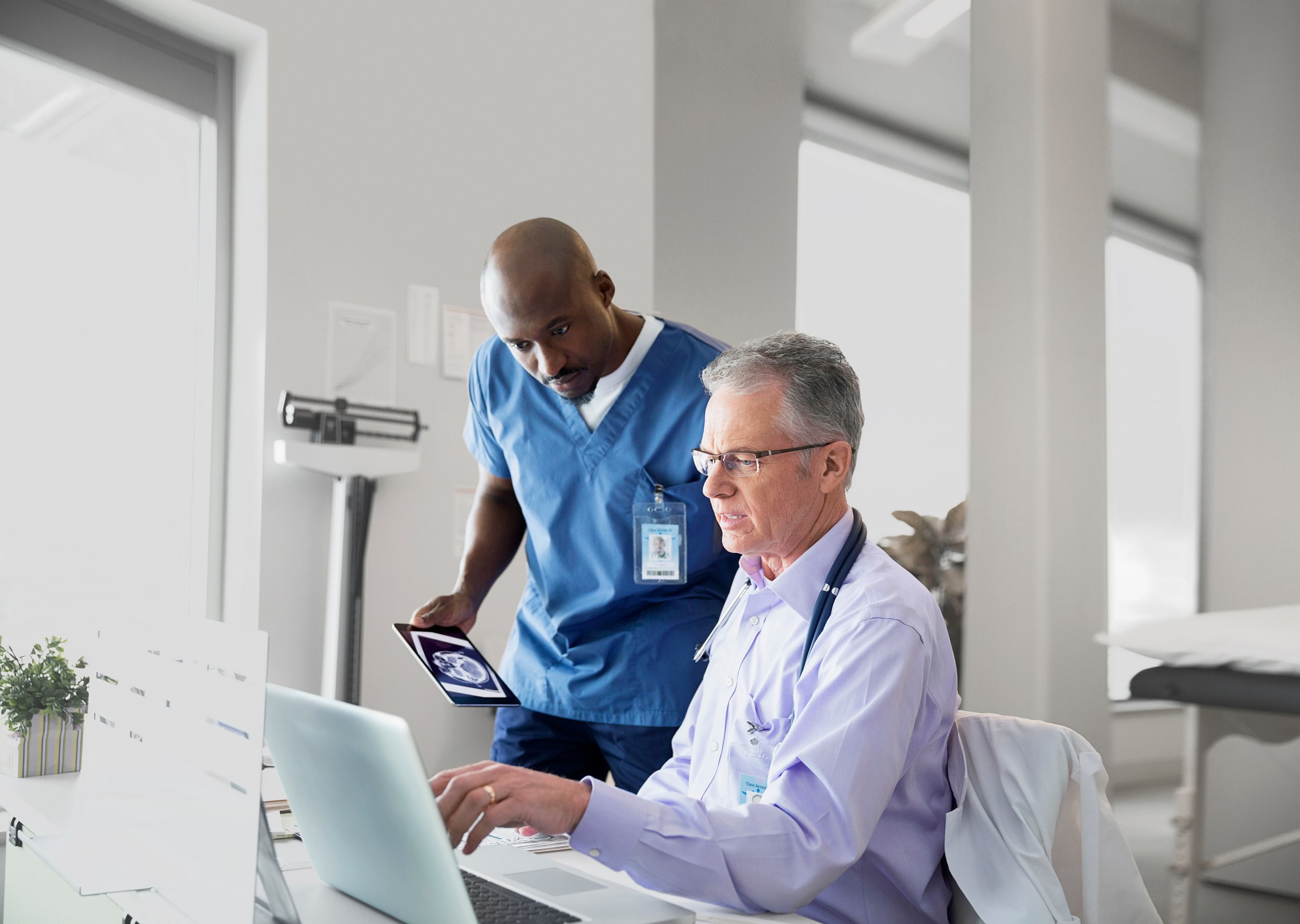 Two people looking at a screen in a professional medical environment