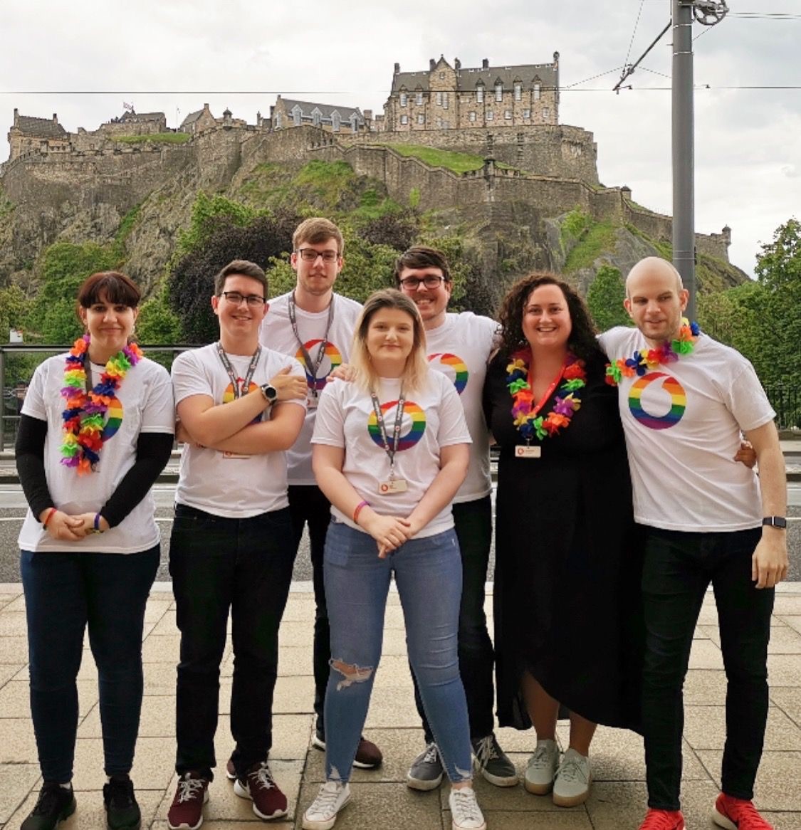 A group of people in Edinburgh with vodafone LGBT logo tops