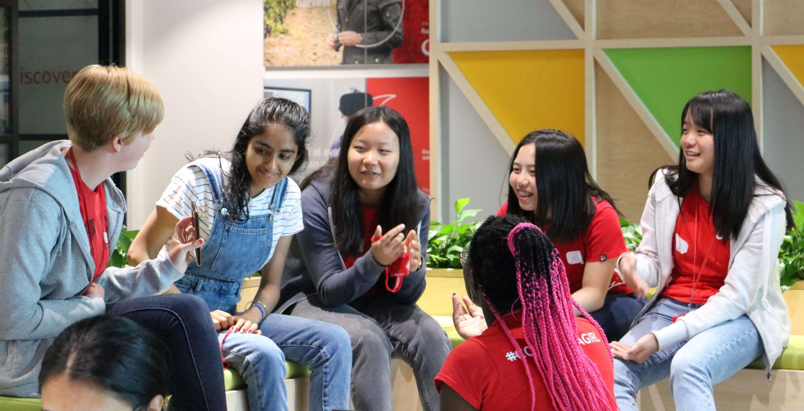 A group of people talking together and smiling at each other