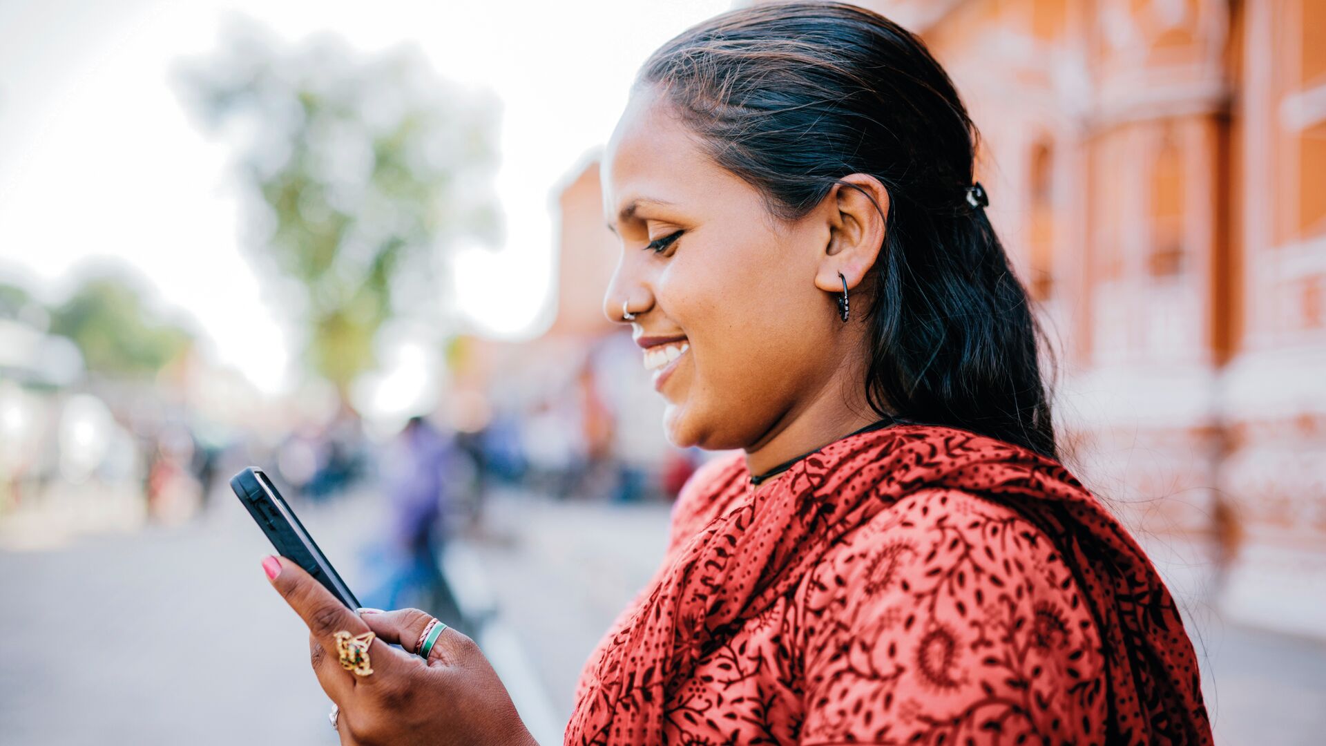 A woman smiling at her phone
