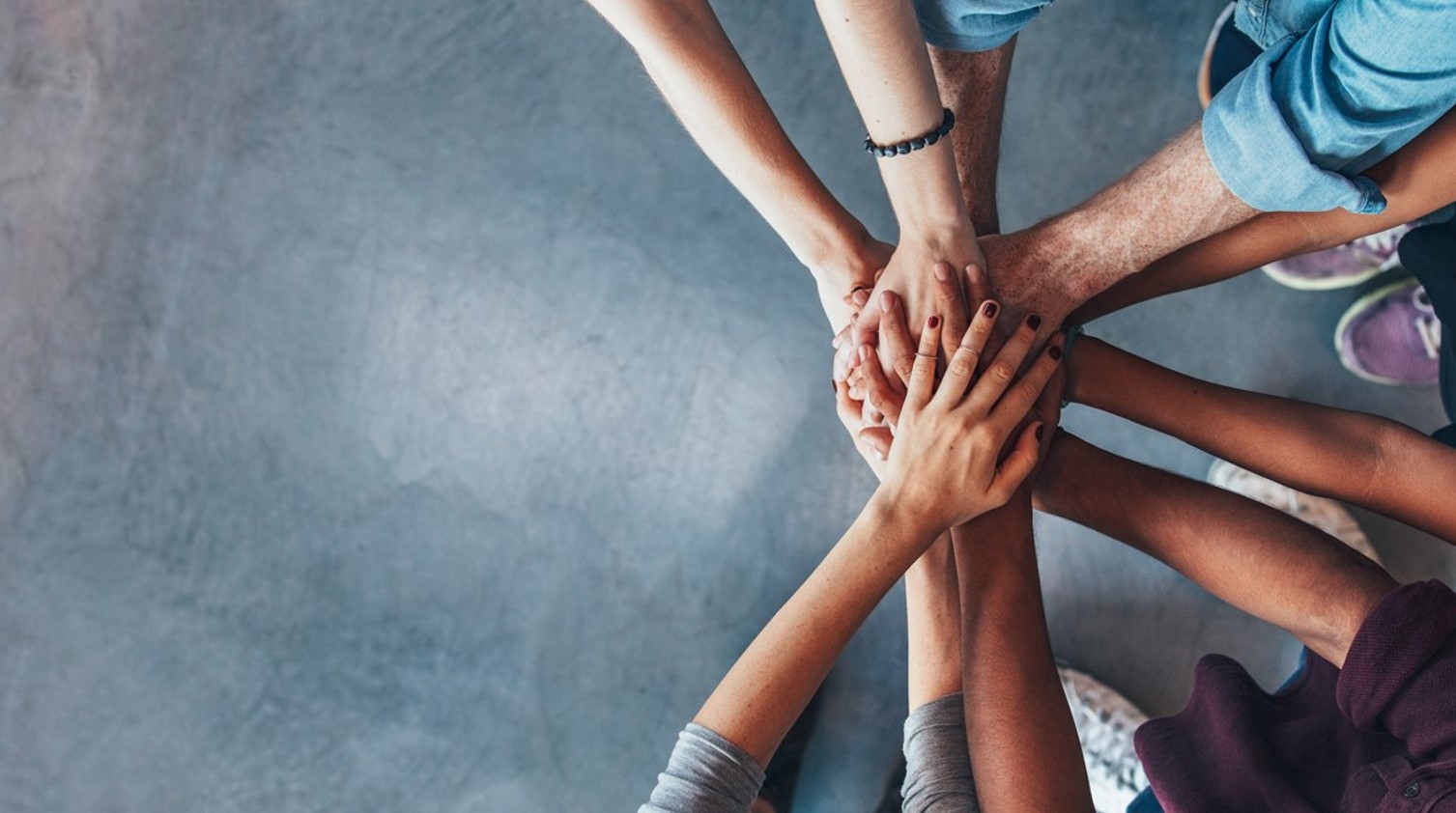 Image of hands in a huddle together