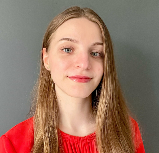 Image of a girl smiling wearing a red top