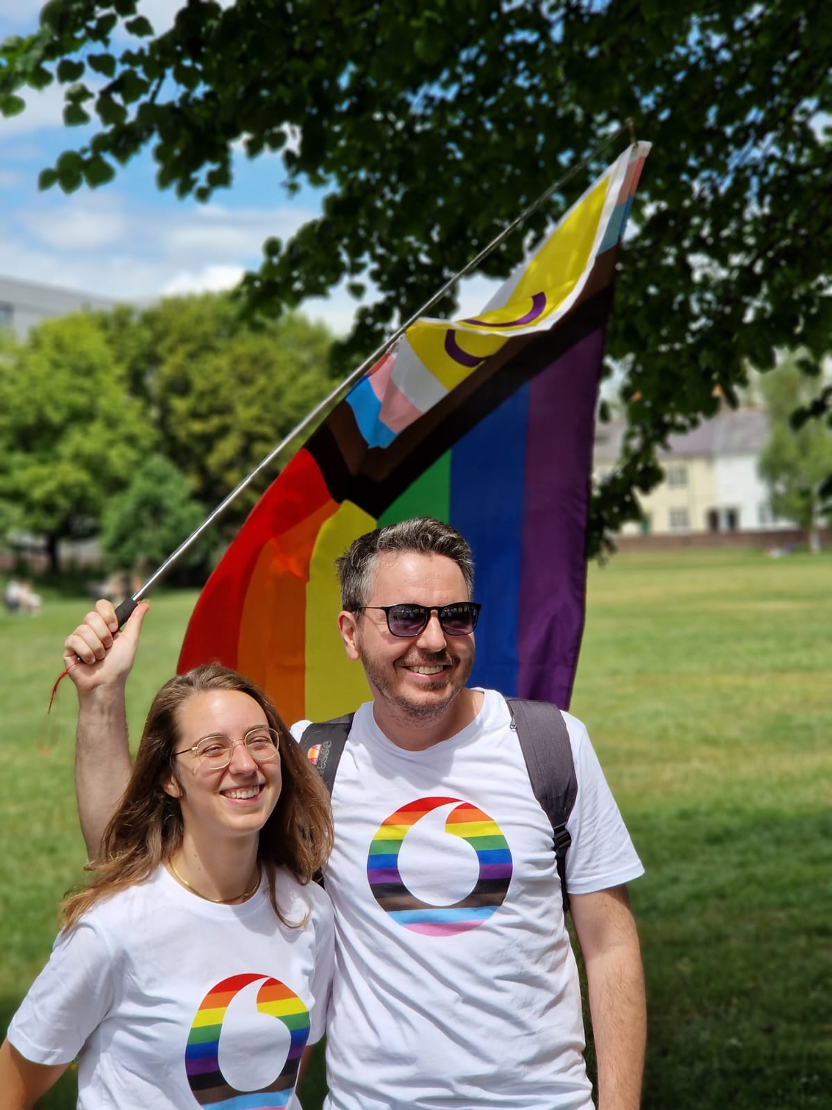Marta and Mihai - our LGBT network leads at Newbury Pride with a pride flag