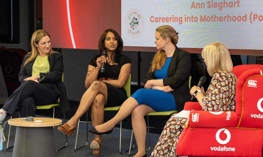 A group of women on a panel discussion at an internal event